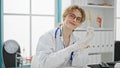 Young woman doctor wearing gloves smiling at the clinic Royalty Free Stock Photo