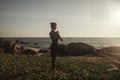 Young woman does yoga for healthy lifestyle on sea beach Royalty Free Stock Photo