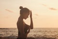 Young woman does yoga for healthy lifestyle on sea beach Royalty Free Stock Photo