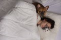 Young woman with dog and cat bask in the morning in her bed Royalty Free Stock Photo