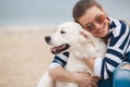 Young woman with a dog on a deserted beach Royalty Free Stock Photo