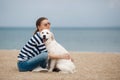 Young woman with a dog on a deserted beach Royalty Free Stock Photo