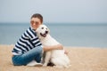 Young woman with a dog on a deserted beach Royalty Free Stock Photo