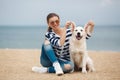 Young woman with a dog on a deserted beach Royalty Free Stock Photo