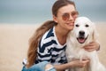 Young woman with a dog on a deserted beach Royalty Free Stock Photo