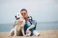 Young woman with a dog on a deserted beach Royalty Free Stock Photo