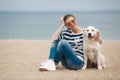 Young woman with a dog on a deserted beach Royalty Free Stock Photo