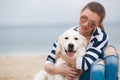 Young woman with a dog on a deserted beach Royalty Free Stock Photo