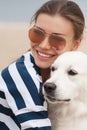 Young woman with a dog on a deserted beach Royalty Free Stock Photo