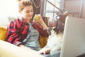 Young woman and dog with laptop . Work at home. Pug