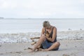 Young woman with dog near sea water on the tropical beach on the island of Zanzibar, Tanzania, Africa Royalty Free Stock Photo