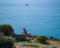 A young woman with a dog is resting while walking in the mountains Royalty Free Stock Photo