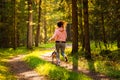 Young woman and dog running together on country in forest. Cheerful female exercising outdoor with her pet. Royalty Free Stock Photo