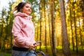 Young woman and dog running together on country in forest. Cheerful female exercising outdoor with her pet Royalty Free Stock Photo