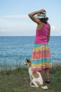 Young woman and dog watching the sea Royalty Free Stock Photo