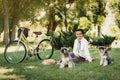 Young woman with dogs and bicycle having picnic in the park Royalty Free Stock Photo