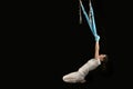 Young woman doing aero fitness gymnastic stretching. Aerial fly yoga and stretching in hammocks. Isolated on black background Royalty Free Stock Photo