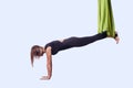 Young woman doing aerial yoga in green hammock. Royalty Free Stock Photo