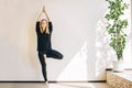 Young woman doing the asana in yoga studio