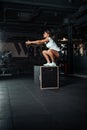 Young woman doing a box jump exercise. Royalty Free Stock Photo