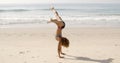 Young Woman Doing Cartwheel On Beach Royalty Free Stock Photo