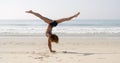 Young Woman Doing Cartwheel On The Beach Royalty Free Stock Photo