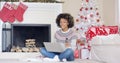 Young woman doing Christmas shopping online Royalty Free Stock Photo