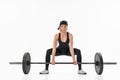 Young woman doing deadlift with a barbell isolated on white Royalty Free Stock Photo