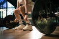 Young woman doing deadlift with heavy bar in gym, strong female athlete with muscular body lifting weights, exercising with Royalty Free Stock Photo