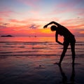 Young woman doing exercise on the beach Royalty Free Stock Photo