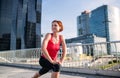 Young woman doing exercise on bridge outdoors in city, stretching. Royalty Free Stock Photo