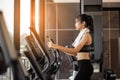 Young woman doing exercise cardio on elliptical trainer at gym Royalty Free Stock Photo