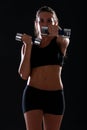 Young woman doing exercise with dumbbells