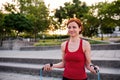 Young woman doing exercise outdoors in city with skipping rope. Royalty Free Stock Photo