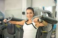 Young woman doing exercises on chest press gym machine in fitness center. Royalty Free Stock Photo