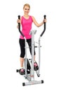 Young woman doing exercises on elliptical trainer Royalty Free Stock Photo