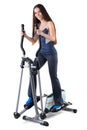 Young woman doing exercises on elliptical trainer Royalty Free Stock Photo