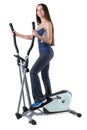 Young woman doing exercises on elliptical trainer Royalty Free Stock Photo