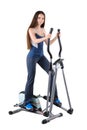 Young woman doing exercises on elliptical trainer Royalty Free Stock Photo
