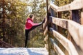 Young woman doing exercises during winter training outside in cold snow weather. Royalty Free Stock Photo