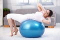 Young woman doing fit ball workout smiling Royalty Free Stock Photo