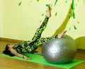 Woman doing fitness exercise, young woman doing fitness exercises with fitness ball in fitness club Royalty Free Stock Photo