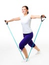 Young woman doing fitness with expander