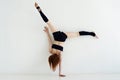 Young woman doing gymnastics or callisthenics