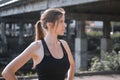 Young woman doing gymnastics on the street. Portrait of fit and sporty young woman doing stretching in city