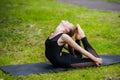 Young woman doing gymnastics yoga and stretching in the city park on sunset Royalty Free Stock Photo