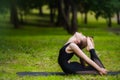 Young woman doing gymnastics yoga and stretching in the city park on sunset Royalty Free Stock Photo