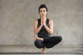 Young woman doing Half Lotus Toe Balance exercise