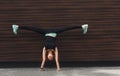 Young woman doing handstand on city street Royalty Free Stock Photo