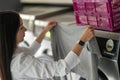 Young woman doing his weekly washing in a laundromat. Royalty Free Stock Photo